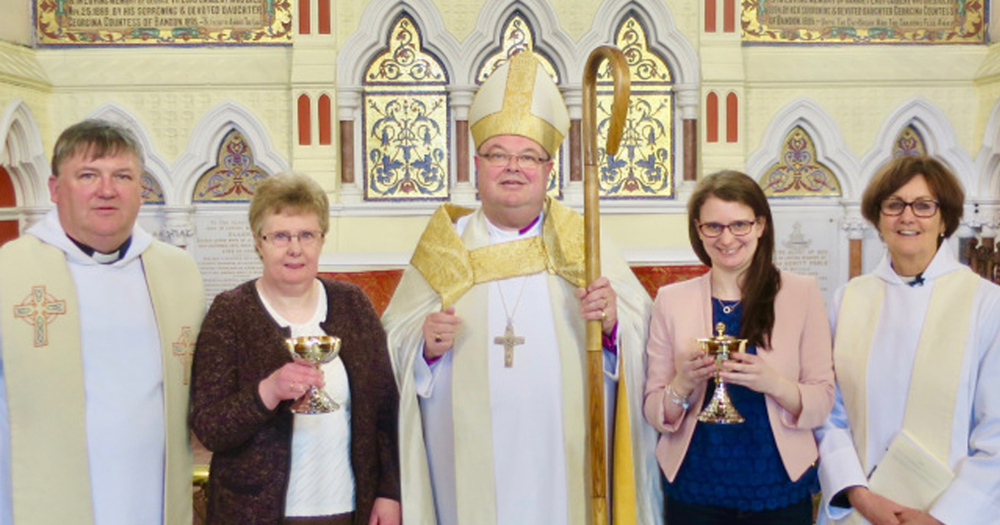 Mrs Anne Kingston (holding the chalice) and her daughter Linda (holding the ciborium) following the consecration of the gifts in memory of Noel Burns, with Bishop Paul Colton, the Reverend Denis MacCarthy (Rector) and the Reverend Anne Skuse (Chaplain to Bandon Grammar School).