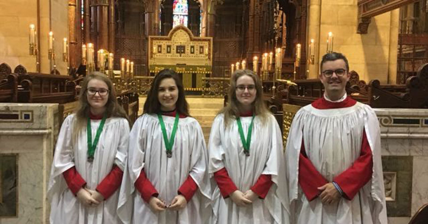 Three choristers of St Fin Barre’s Cathedral, Cork, who recently received the RSCM bronze award with the Director of Music, Mr Peter Stobart.
