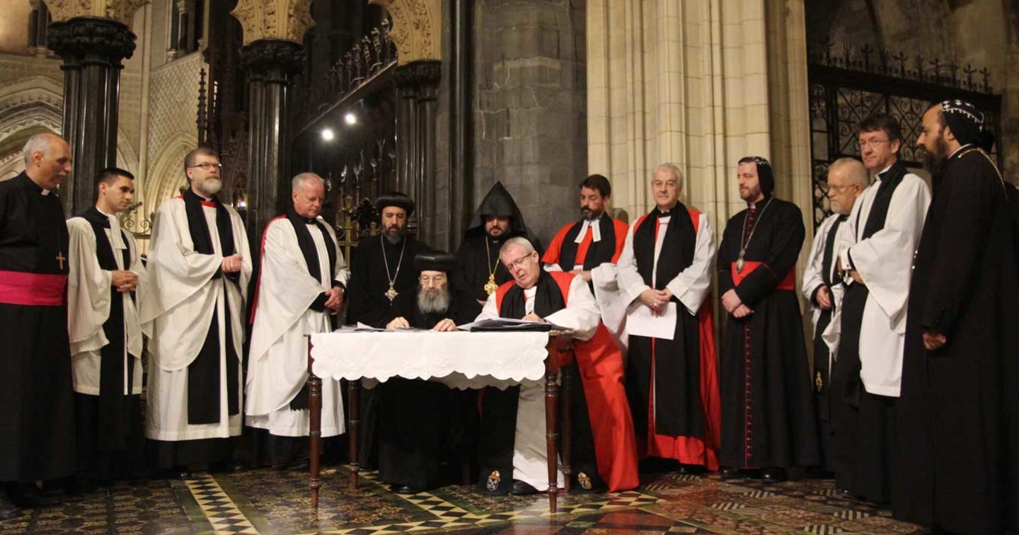 The Co Chairs of AOOIC, the Rt Revd Gregory K Cameron and His Eminence Metropolitan Bishoy, sign the Dublin Agreement in Christ Church Cathedral as members of the Commission look on.