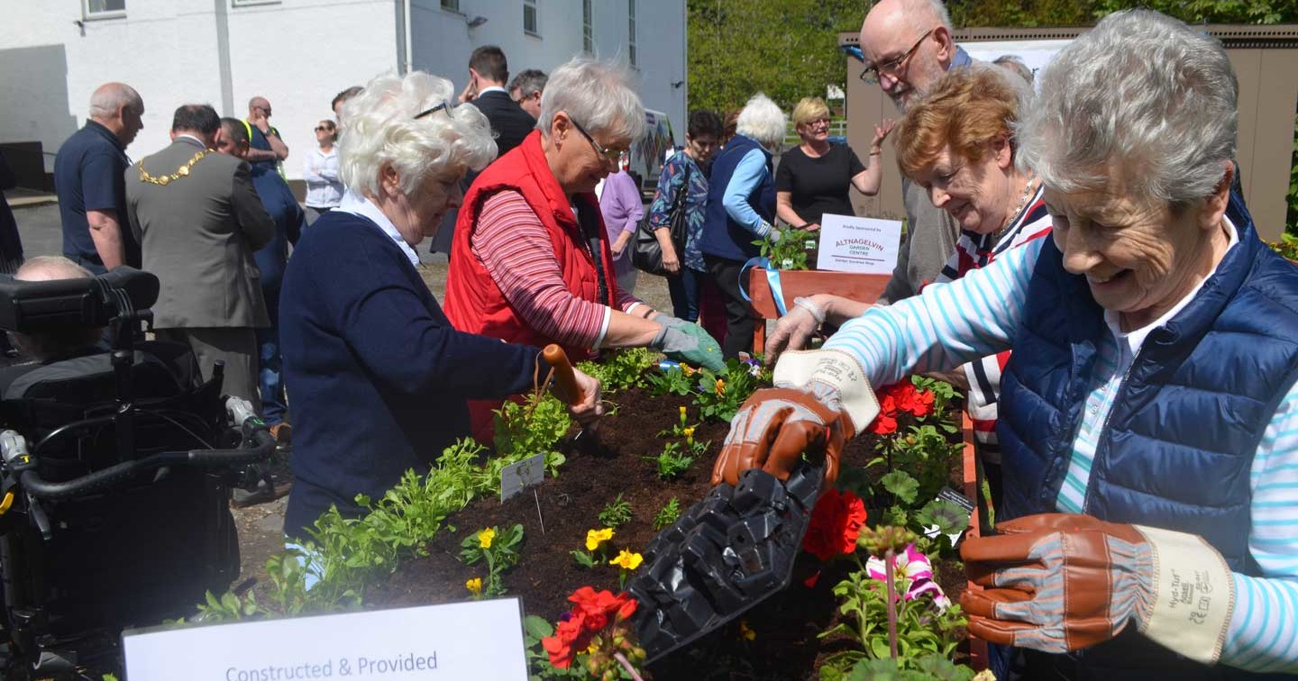 Members of the Thursday Club tend to the raised flower and vegetable beds at the Acorn Centre on Culmore Road.