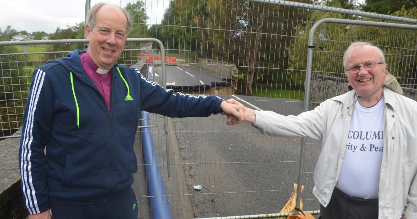 Bishop Ken Good and Bishop Donal McKeown by a flood–damaged bridge before setting off on their pilgrimage walk.