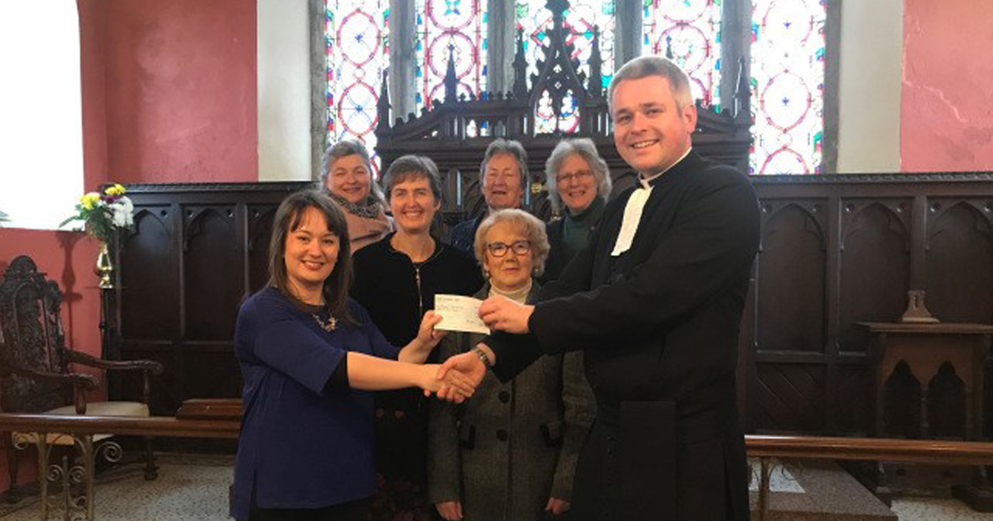 The Rector of Cobh and Glanmire Union of Parishes, the Revd Paul Arbuthnot, together with representatives of the parish and wider community, presents a cheque to Vivienne O’Mahony of the Cork Simon Community.