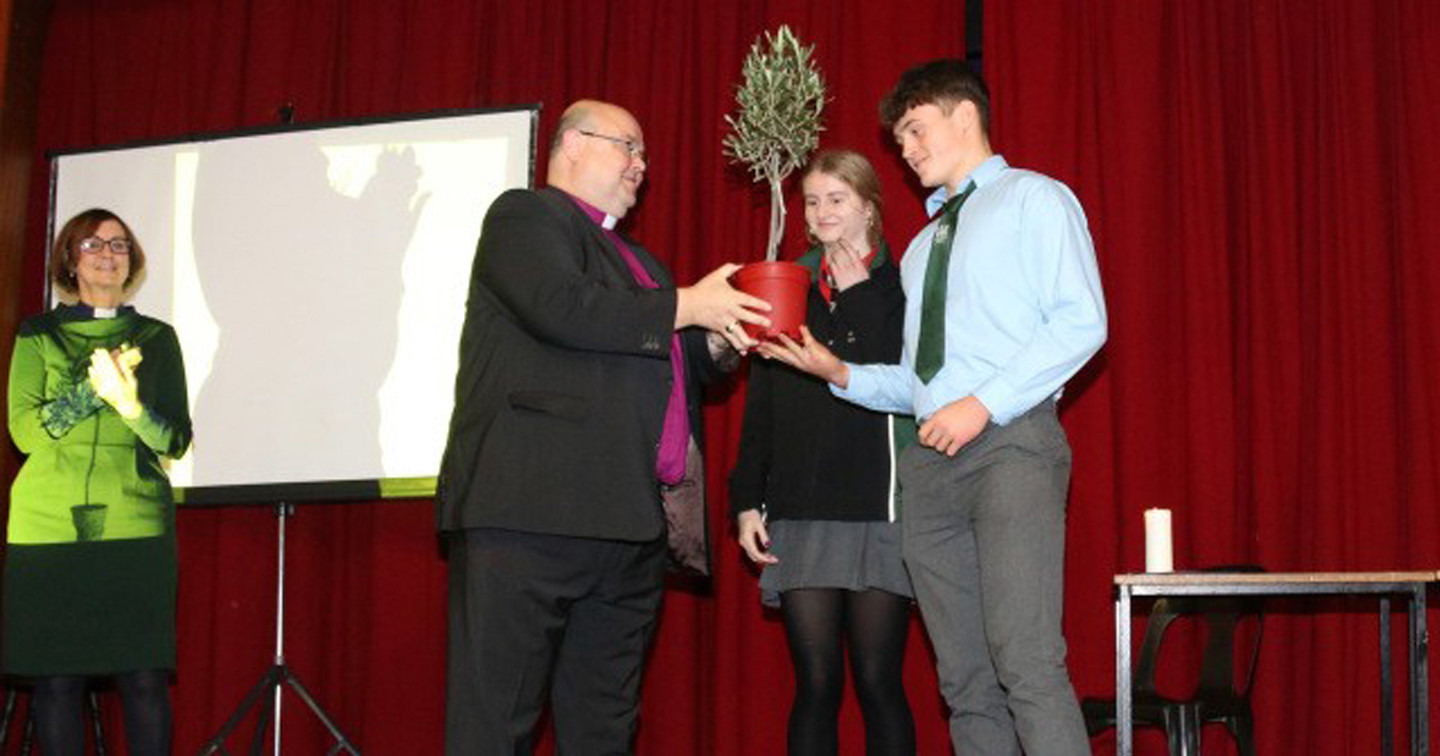 A tree is presented at Bandon Grammar School at an assembly arranged by the Chaplain, the Reverend Anne Skuse (left).