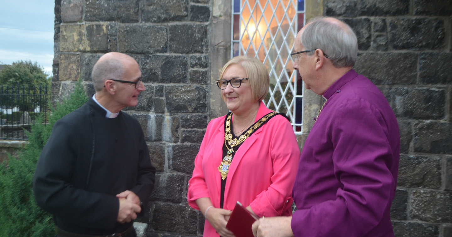 The new Rector of Camus–Juxta–Bann, the Rev Paul Lyons, and the Bishop of Derry and Raphoe, the Rt Rev Ken Good, greet the Mayor of Causeway Coast and Glens Borough Council, Cllr Brenda Chivers, at St Mary’s Church in Macosquin.