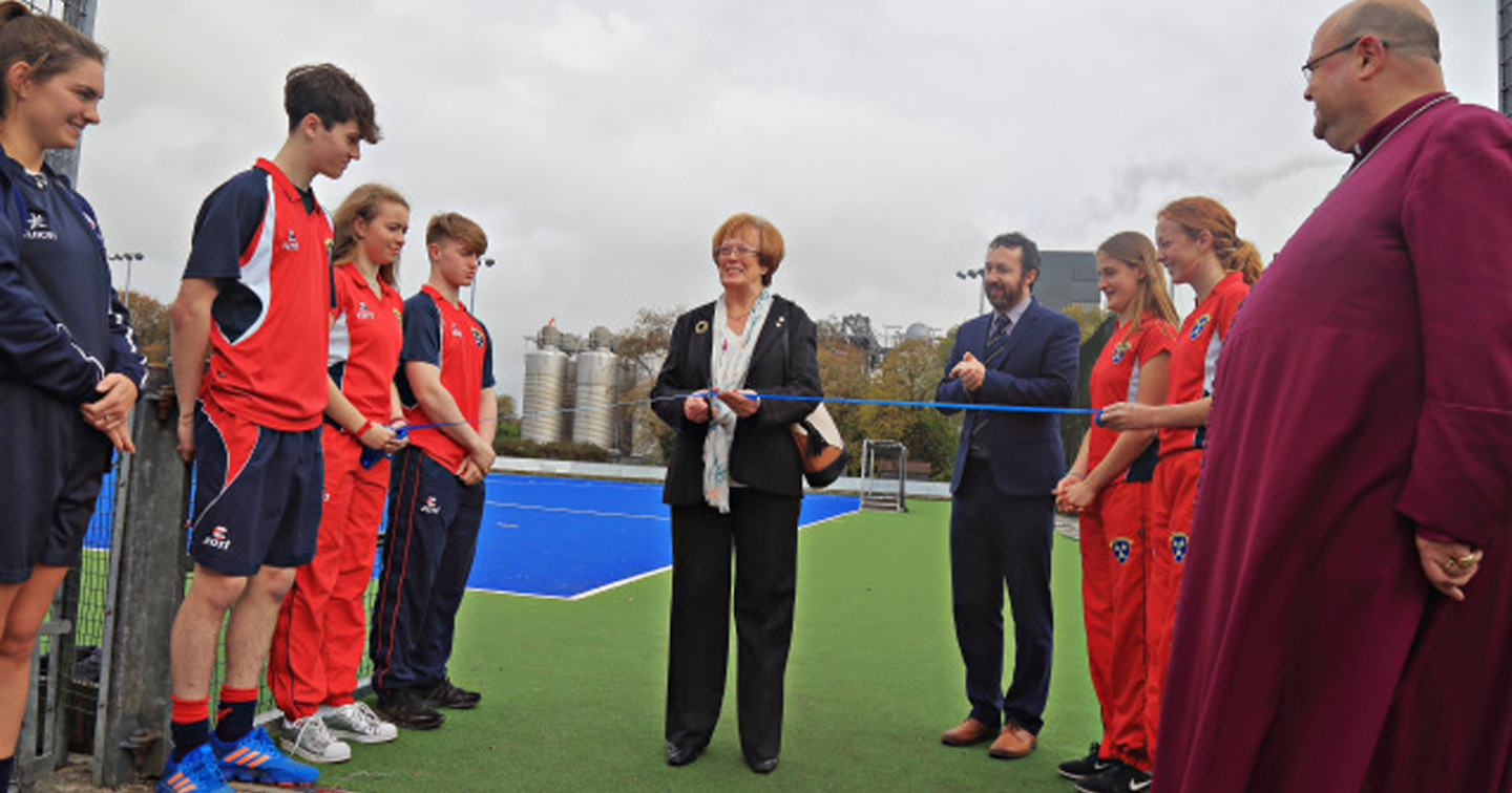 Mrs Maura Lee West turns the first sod for the new Trevor West Sports Complex at Midleton College watched by invited guests, and Dr Edward Gash, Principal, and Bishop Paul Colton, Governor. 