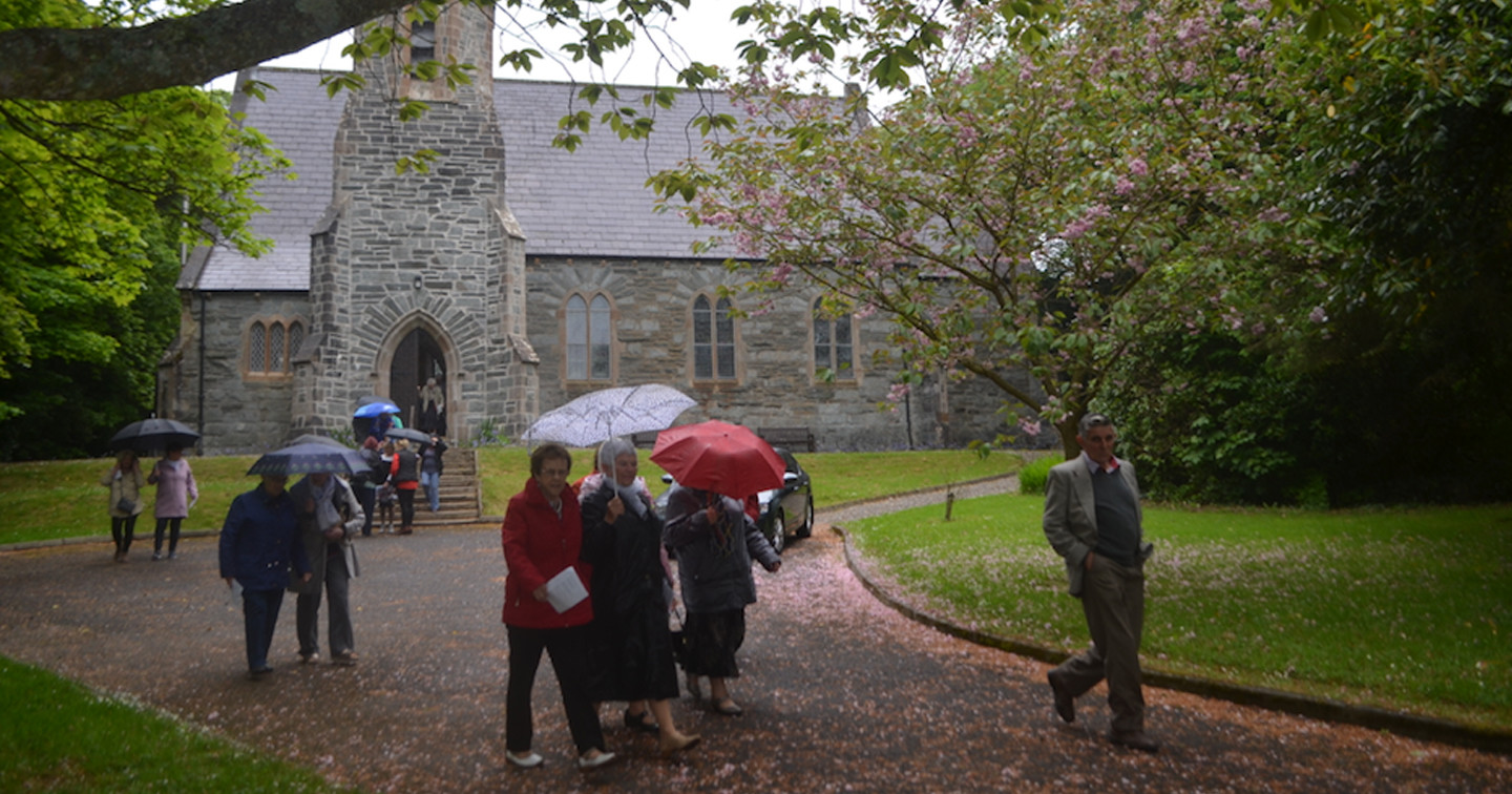 People leaving St Columb's Church of Ireland in Moville on the second leg of their Pentecost Walk of Witness.
