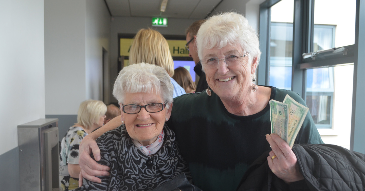 Faughanvale parishioners Cissie McIntyre and Joan Winters collect their £10 notes for St Canice's Church's ‘You’ve Got Talent’ initiative.