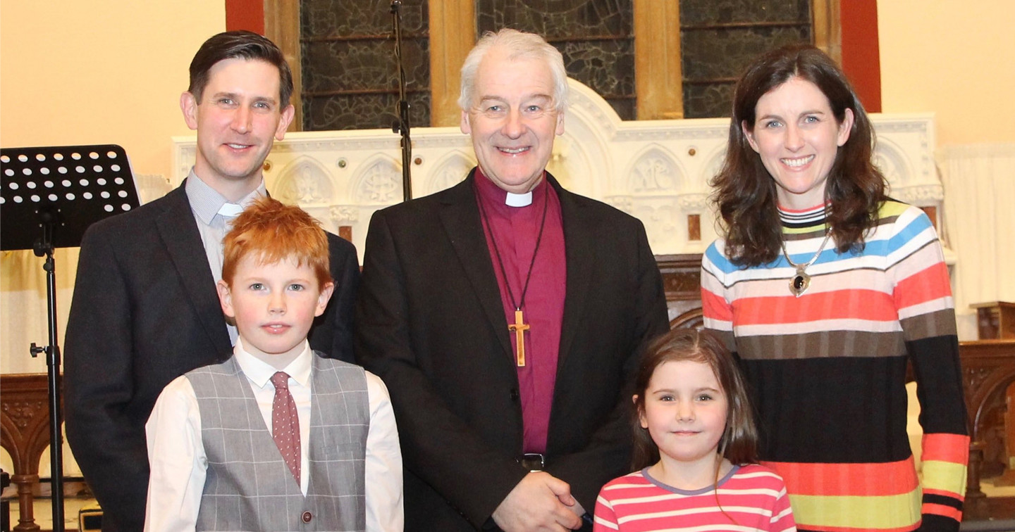 The Revd David Martin, his wife Honour and two of their children with Archbishop Michael Jackson.