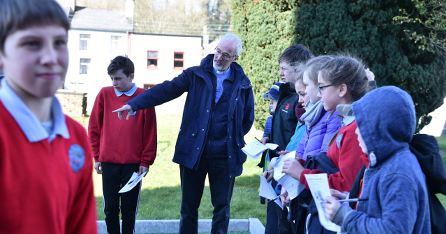 The Rev. Cliff Jeffers explaining the story of Sam Maguire at Sam's grave.