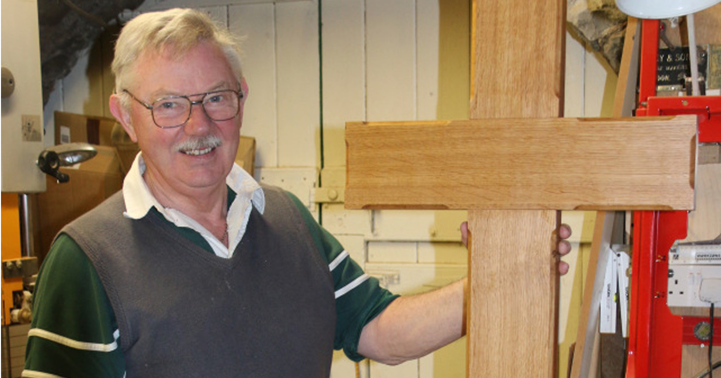 President of the Cork Chapter of the Woodturners’ Guild – John Ahern – with the cross made in memory of his friend and fellow master craftsman, George Colton.