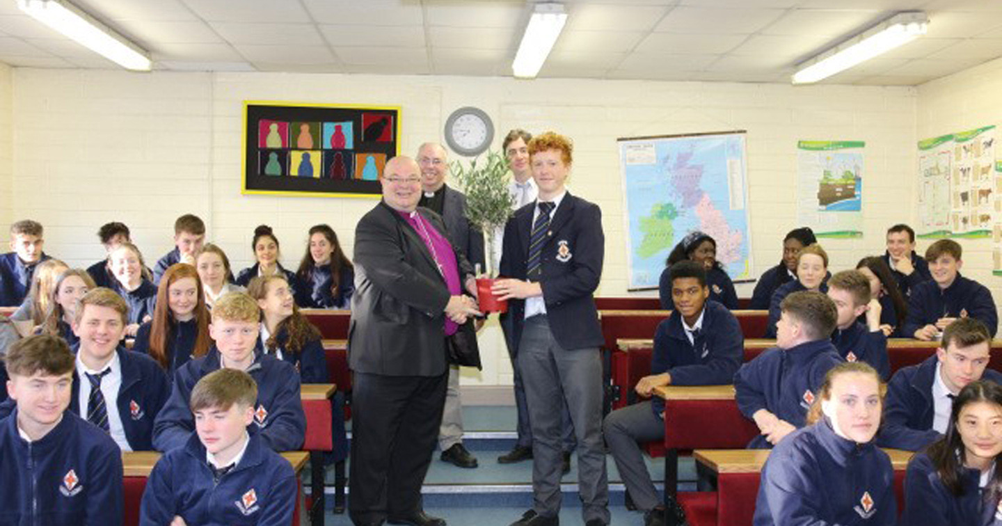 Sixth years at Midleton College receive the olive tree from the Bishop, watched by school chaplain, the Reverend Andrew Orr (back left) and history teacher Christopher Baker.