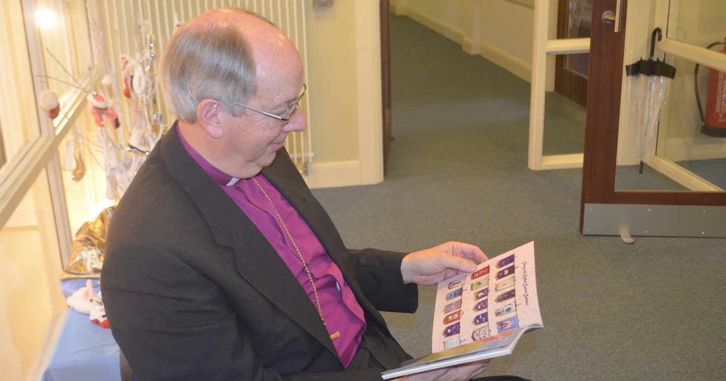 The Bishop of Derry and Raphoe, the Rt Rev Ken Good, sneaks a peak at the Mothers' Union's new book, 'Faith in Action', prior to its launch in the Diocesan Centre last weekend.
