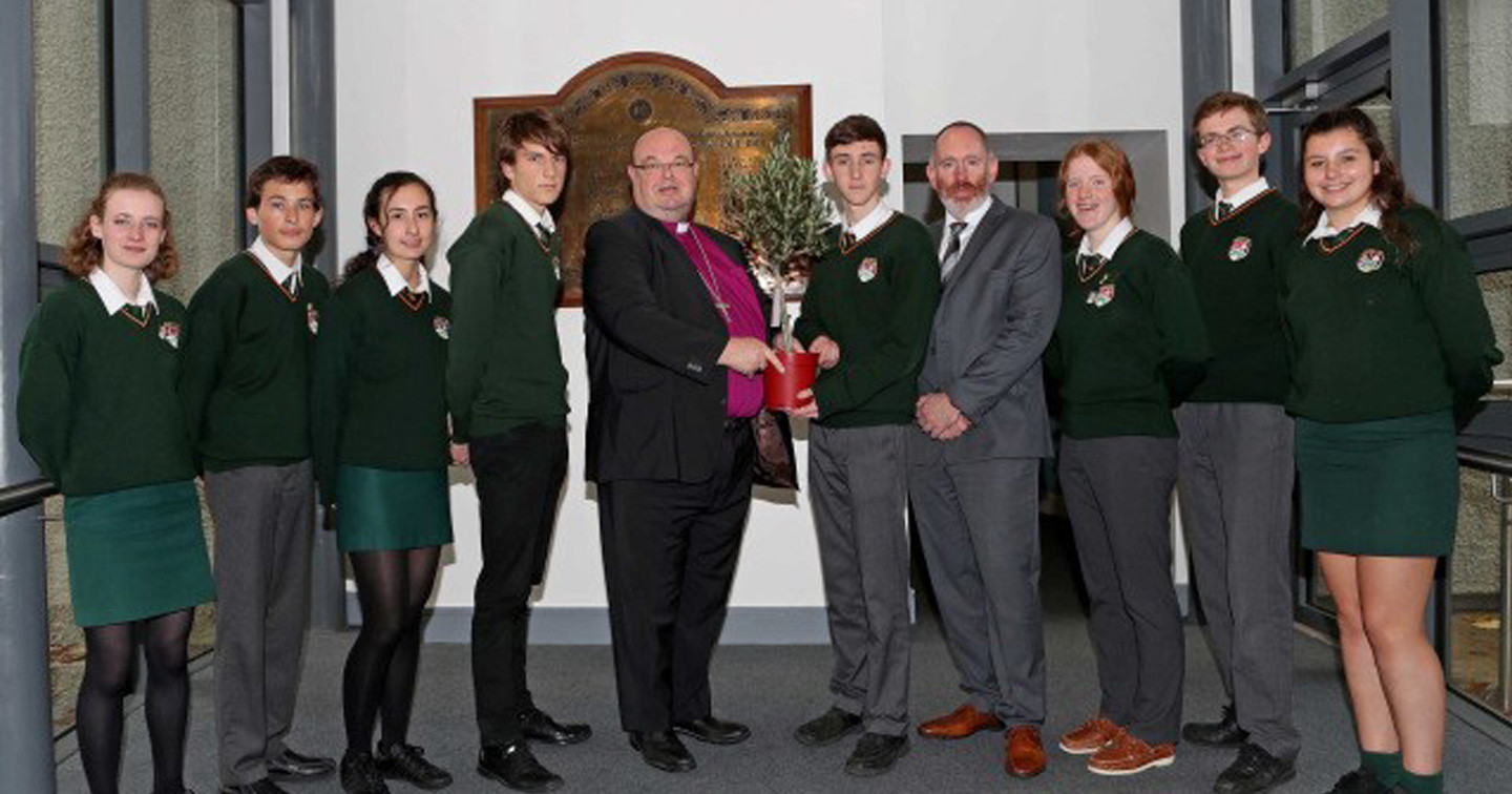 Bishop Paul Colton, presents an Olive Tree at Ashton School, the traditional Symbol of Peace. In the background is the school war memorial listing the names of 53 pupils and past-pupils of the school who died in the First World War.
Picture: Jim Coughlan.
