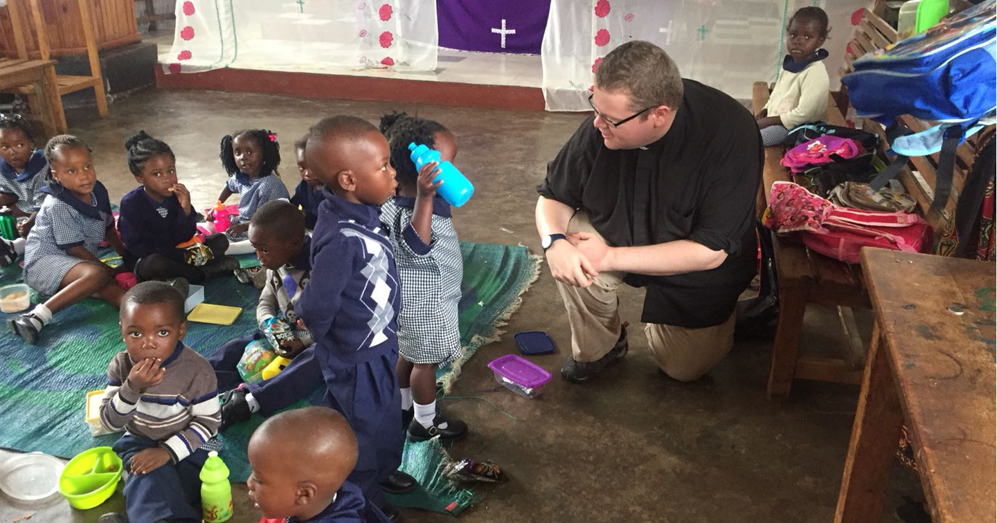 The Revd Adrian Dorrian with the children in the school based at St John’s, Chingola.