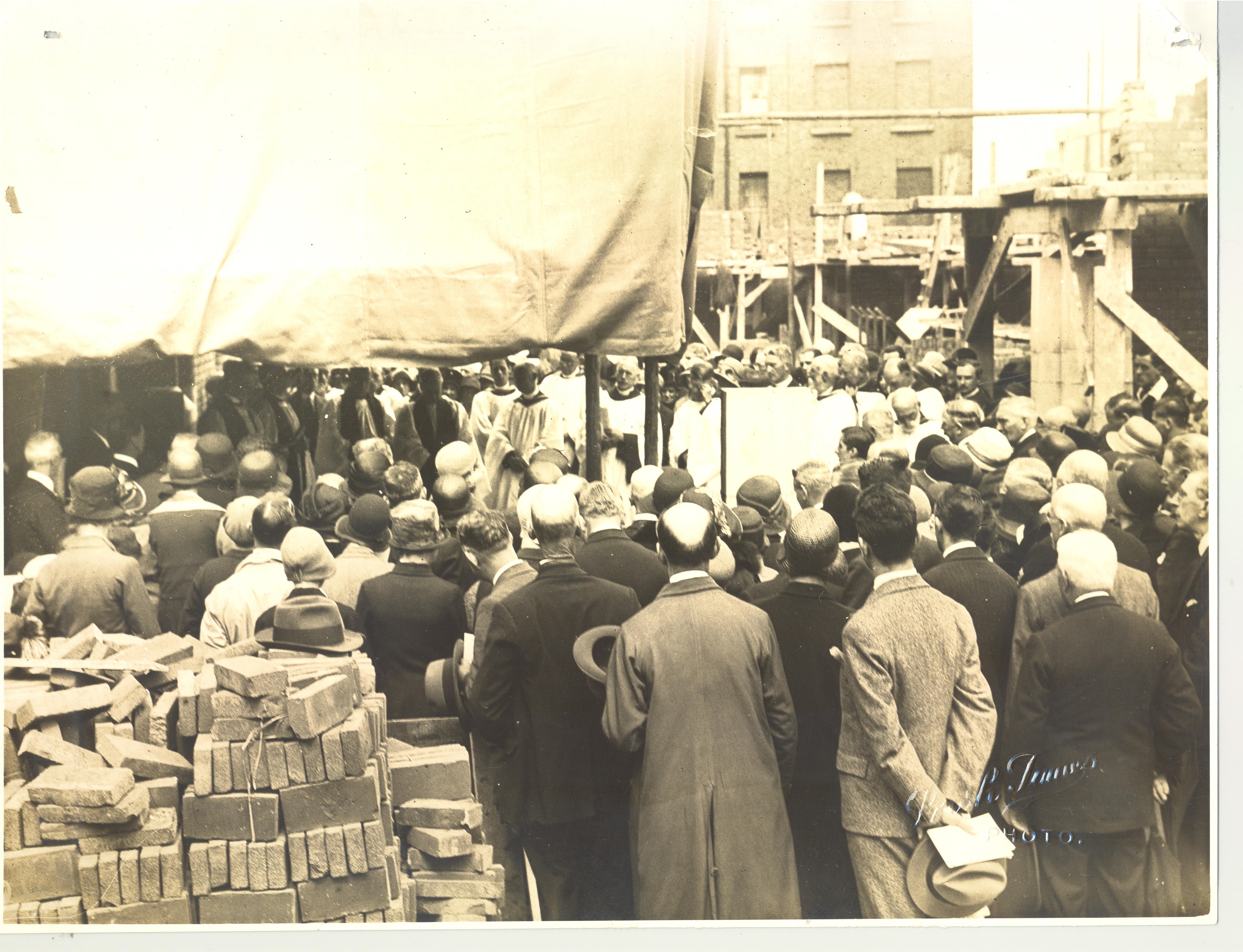 An evocative photograph taken during the laying of the foundation stone on 28 June, 1930, showing a crowd of people attempting to catch a glimpse of the Archbishop. RCB Library P.80.29.2