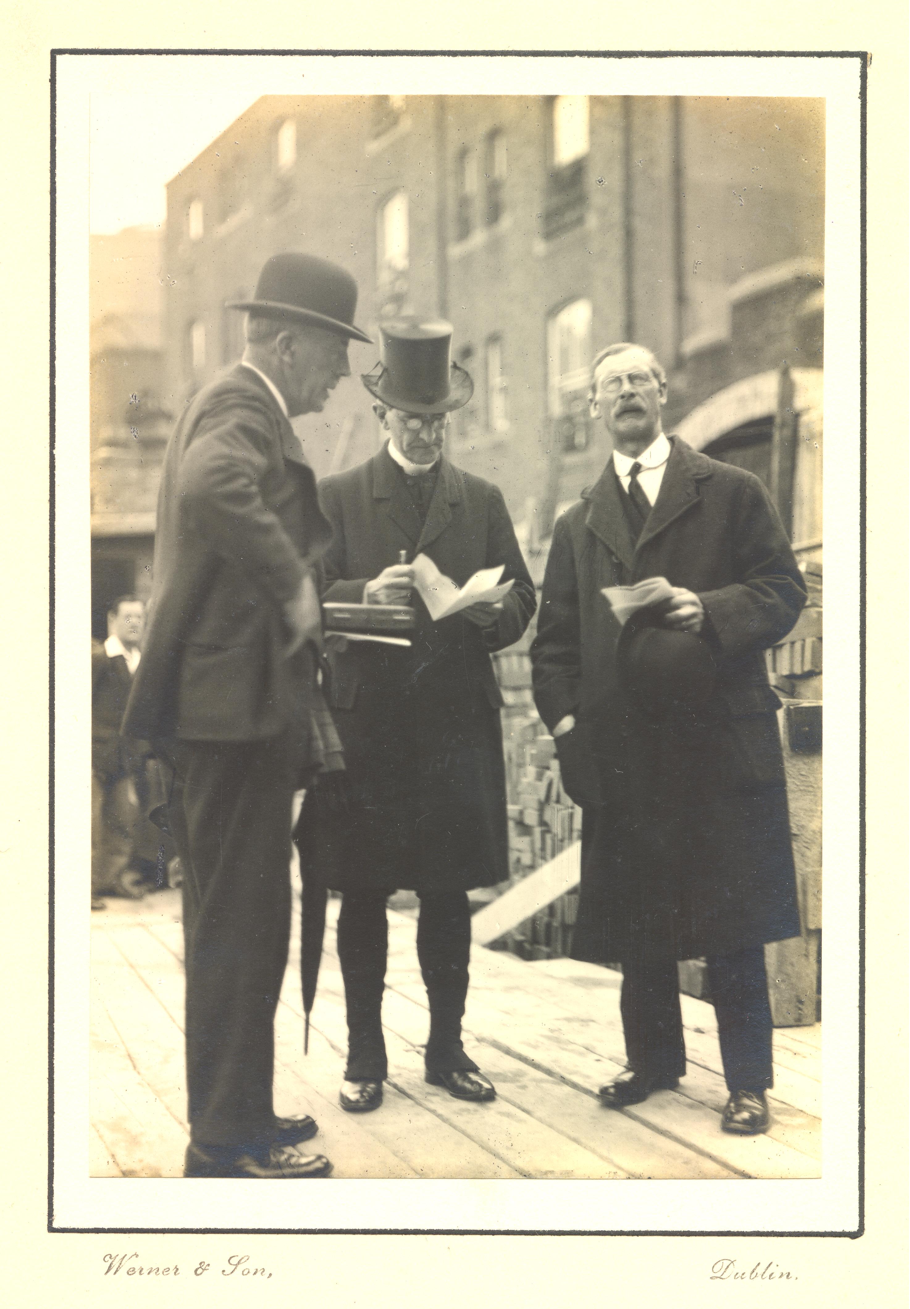 Although there is no written identification of the individuals, it is likely that this shows the architect, Frederick Hicks on the far-right surveying the area where the new church will be built P.80.29.2