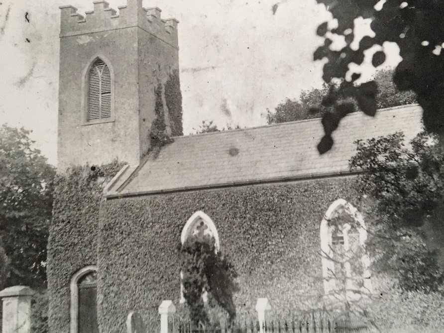 The image of Geashill parish church from the postcard, circa 1900, covered in ivy.