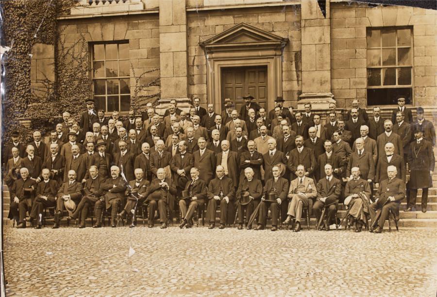 Group portrait of the members of the Irish Convention at Trinity College, taken on 21 August 1917, at front of building [Dining Hall?] in courtyard'. This image is reproduced courtesy of the National Library of Ireland, NPA Conv.