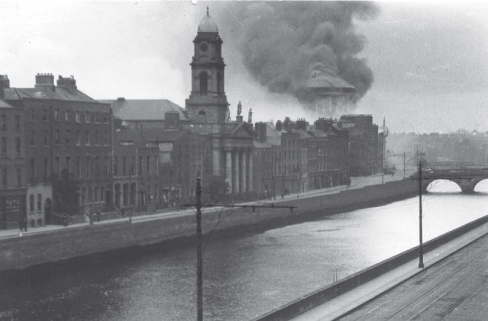 Dark smoke from the Four Courts dome mixes with white smoke from the PROI Record Treasury out of shot to the left, 30 June 1922. Reproduced with the permission of the Irish Architectural Archive.. © Irish Architectural Archive, 10/35 V 1