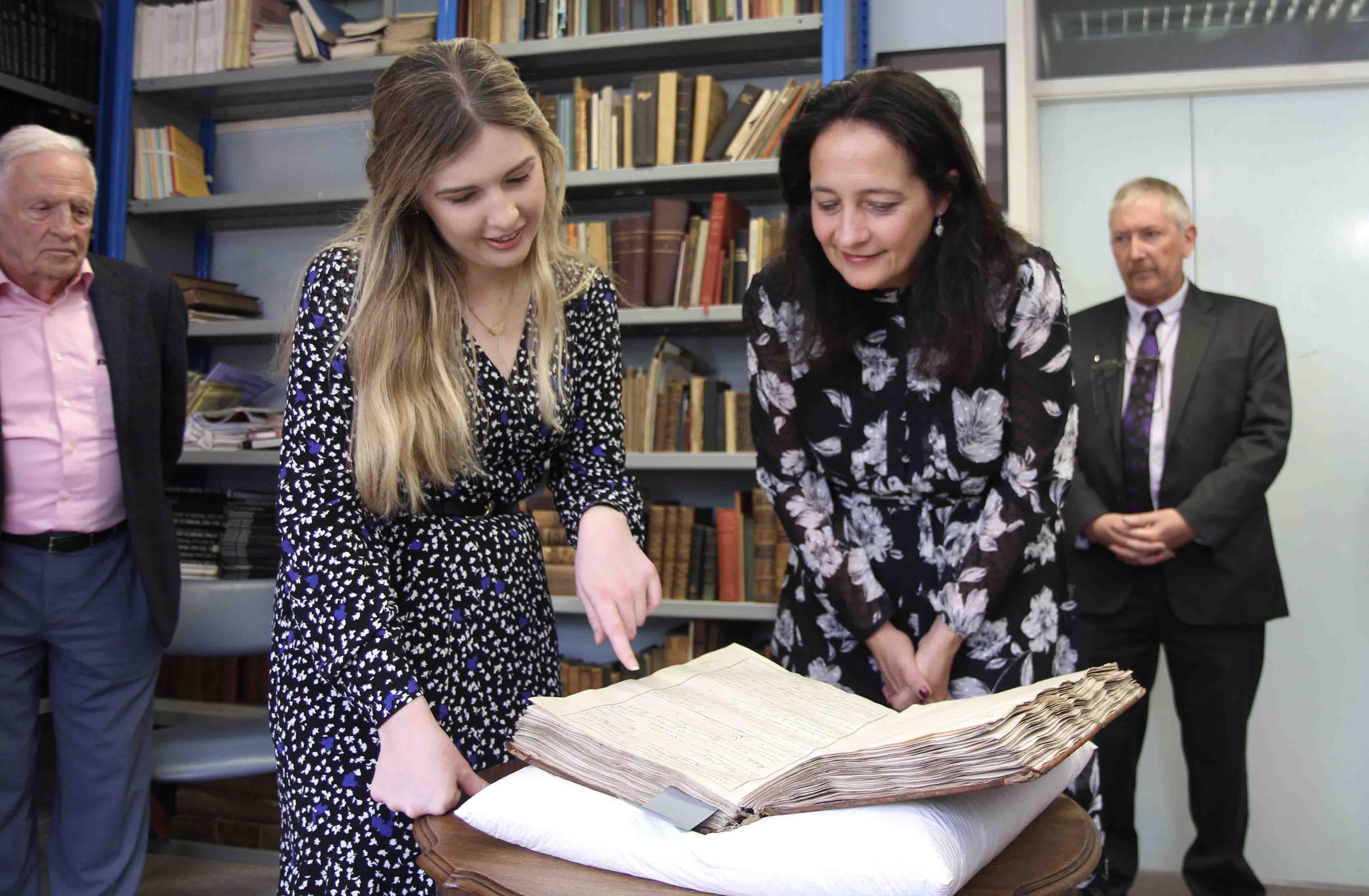 Assistant Archivist Aisling Irwin explains her role to Minister Catherine Martin.