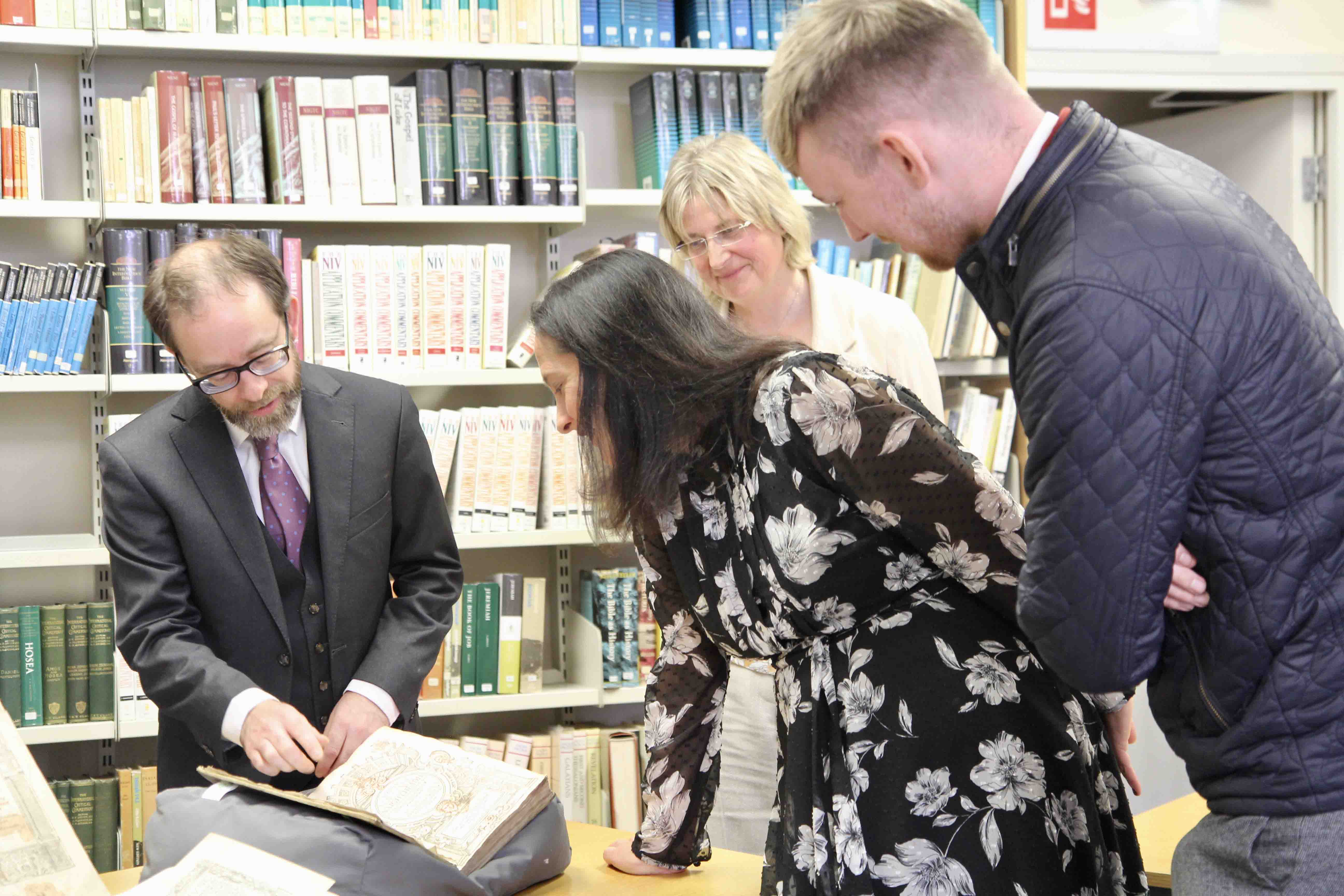 Bryan Whelan shows Minister Catherine Martin and her staff rare editions of the Book of Common Prayer.