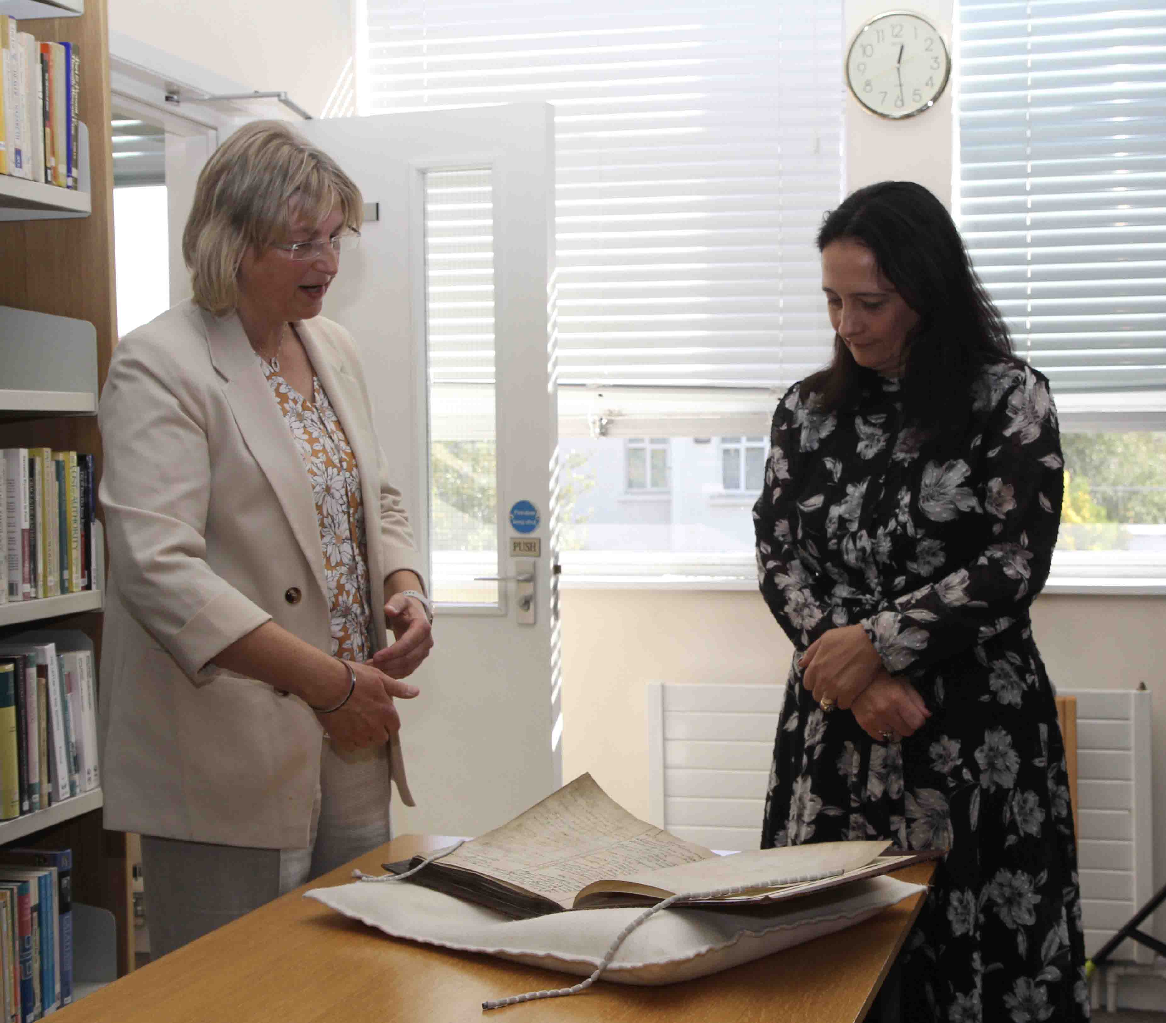 Dr Susan Hood shows Minister Martin some of the Library's collections.