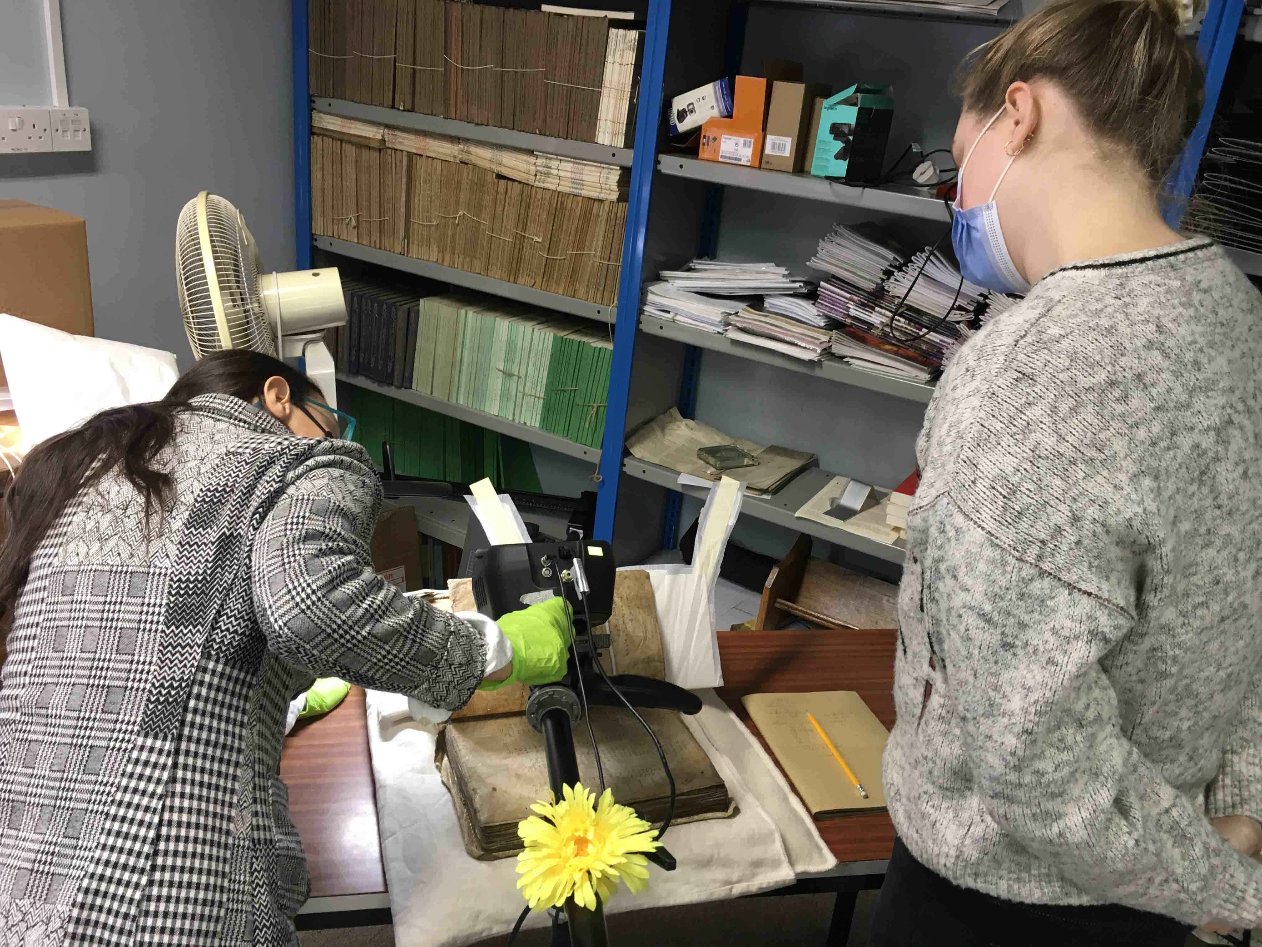 Professor Pádraig Ó Macháin's PhD students (left) Veronica Biolcati, from Italy, working with (right) Anna Hoffmann, from New York, as they position the XRF scanner over the Red Book in the RCB Library.