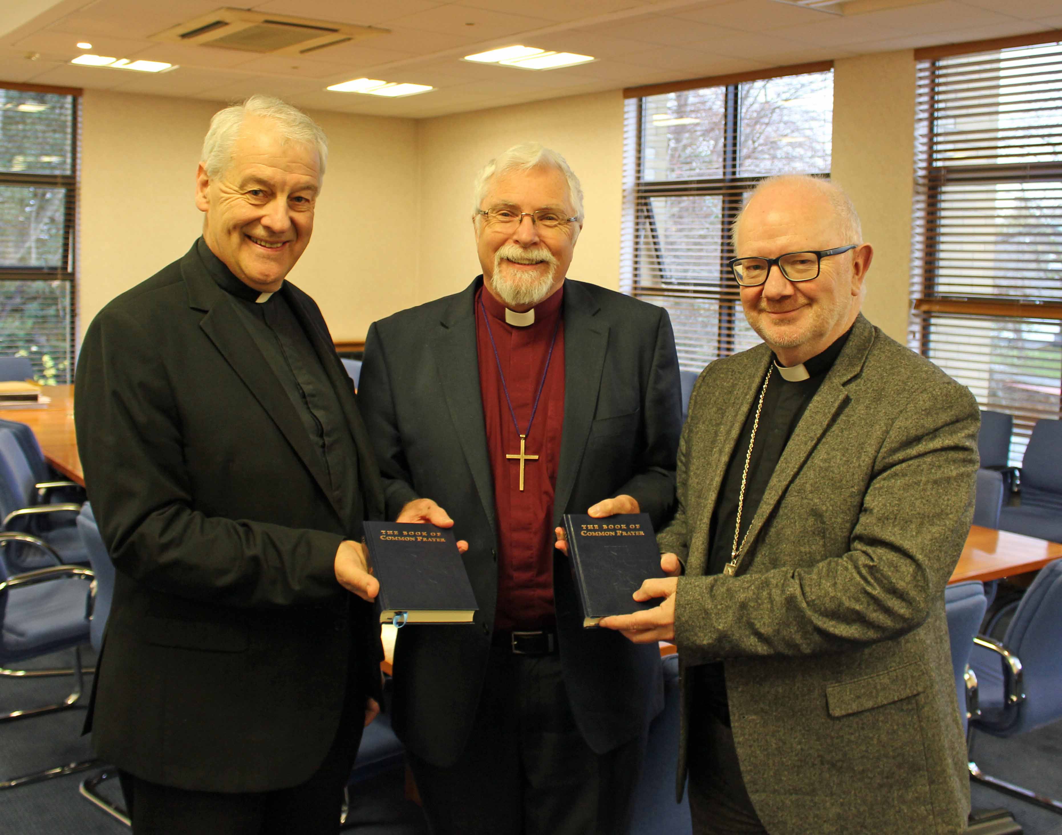 Bishop Harold Miller, Chair of the Book of Common Prayer Working Group, presents review copies of the revised Book of Common Prayer, to the Archbishop of Armagh and the Archbishop of Dublin.