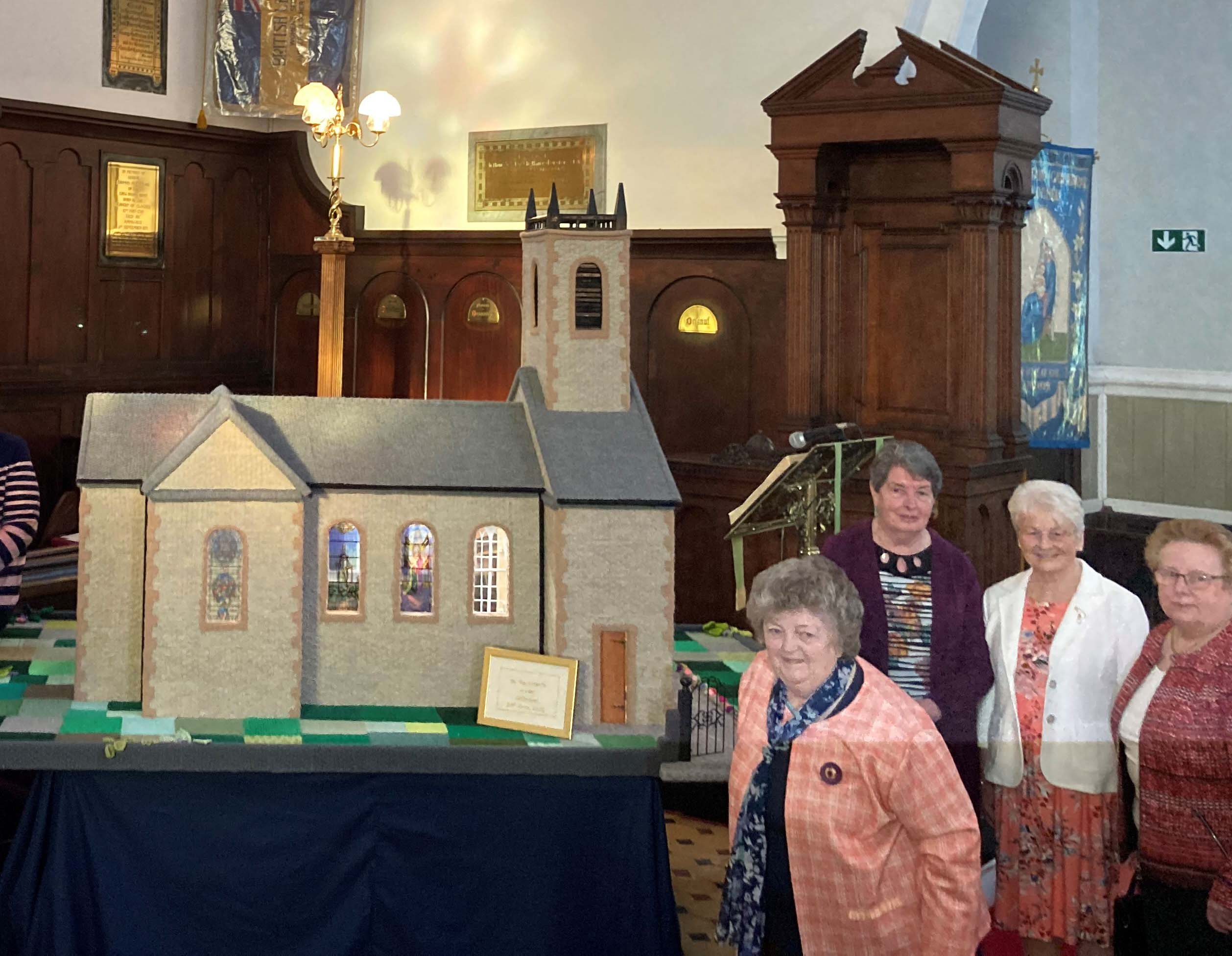 Members of the Knit Stitch and Natter Group with their model Cathedral.