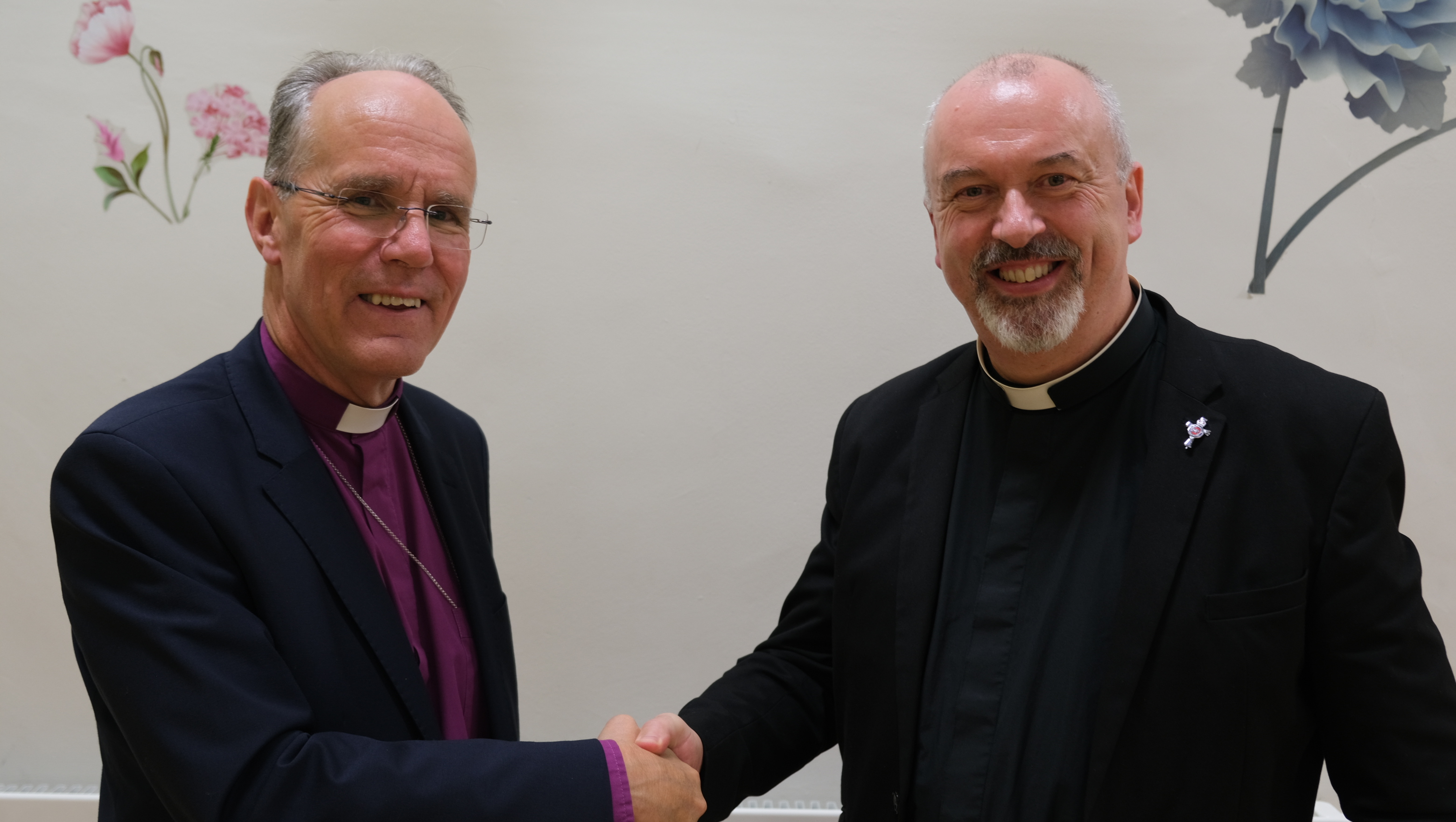 Bishop Ellis congratulates Archdeacon Thompson.