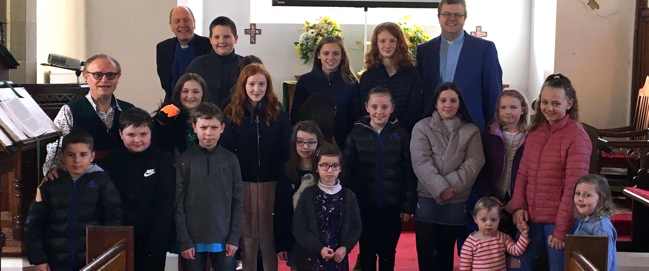 Pictured above: Nick Harding, along with Revd Captain Scott McDonald and Revd Adrian Dorrian (Team Vicars in LAMP) and some of the children and young people at the Pop Up All Age Service.