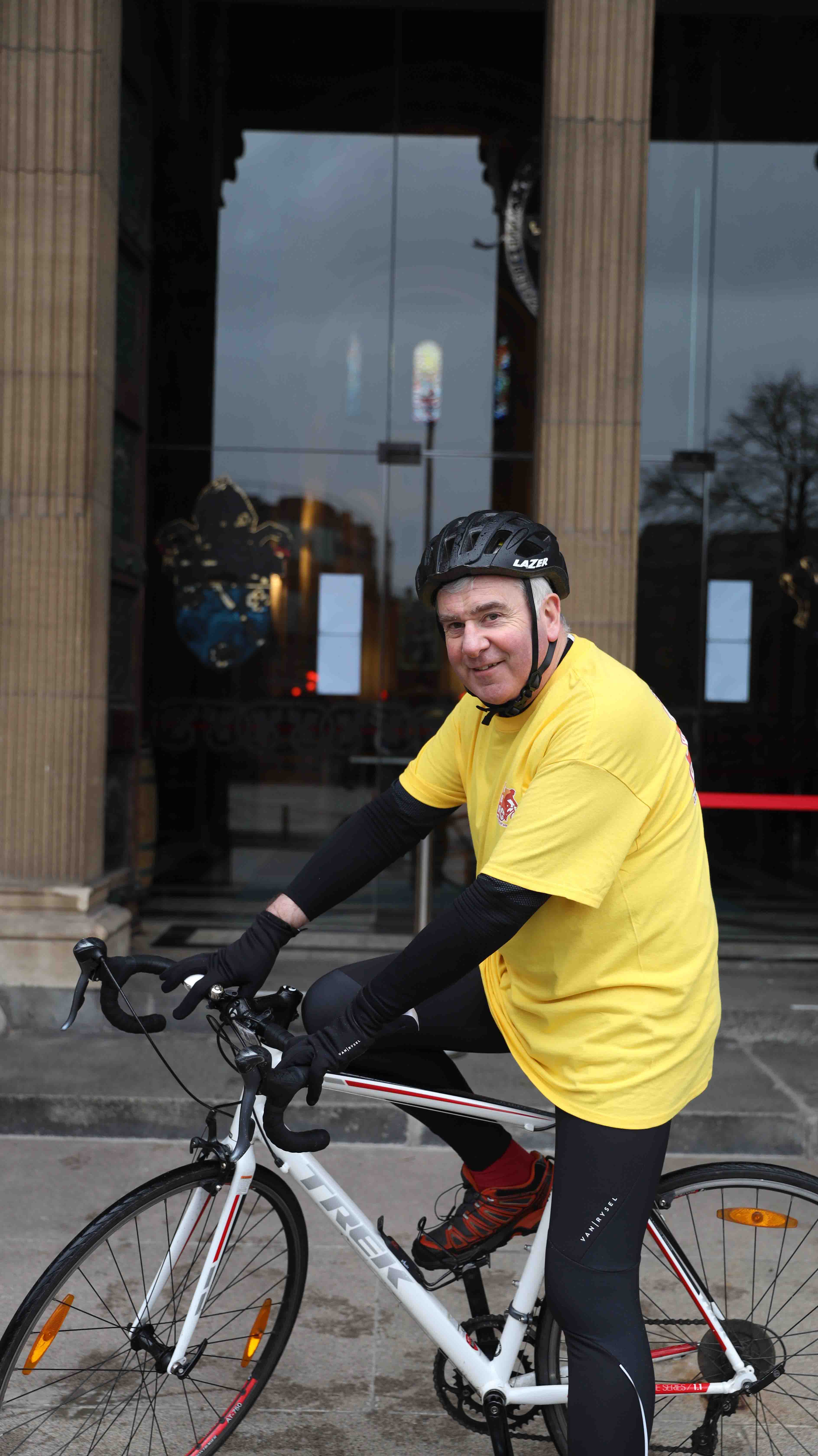 Bishop David McClay on his bicycle at Belfast Cathedral.