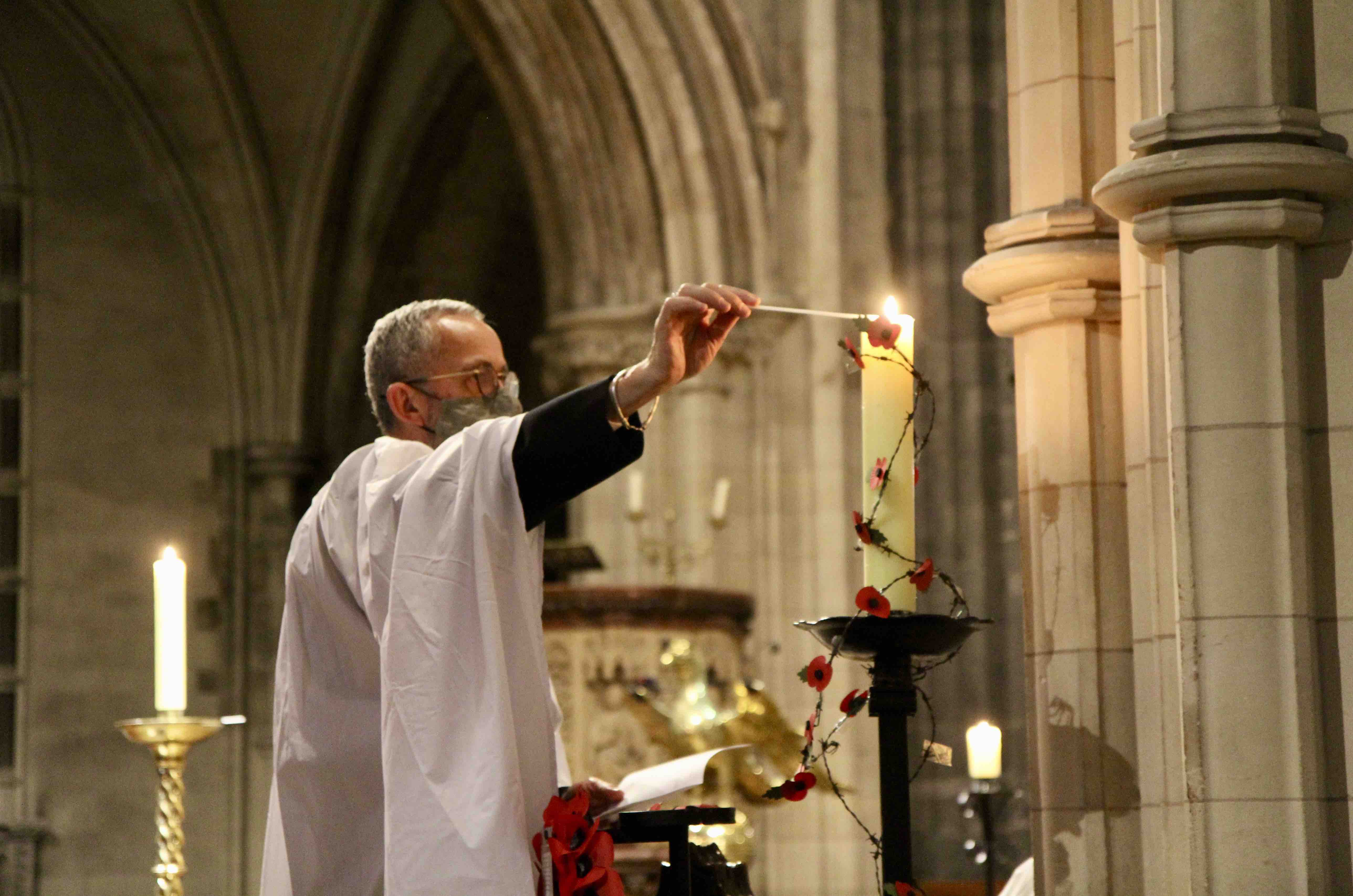 Dean Dermot Dunne lights a candle during the Service of Light. Dean Dermot Dunne, lights a candle during the Service of Light.