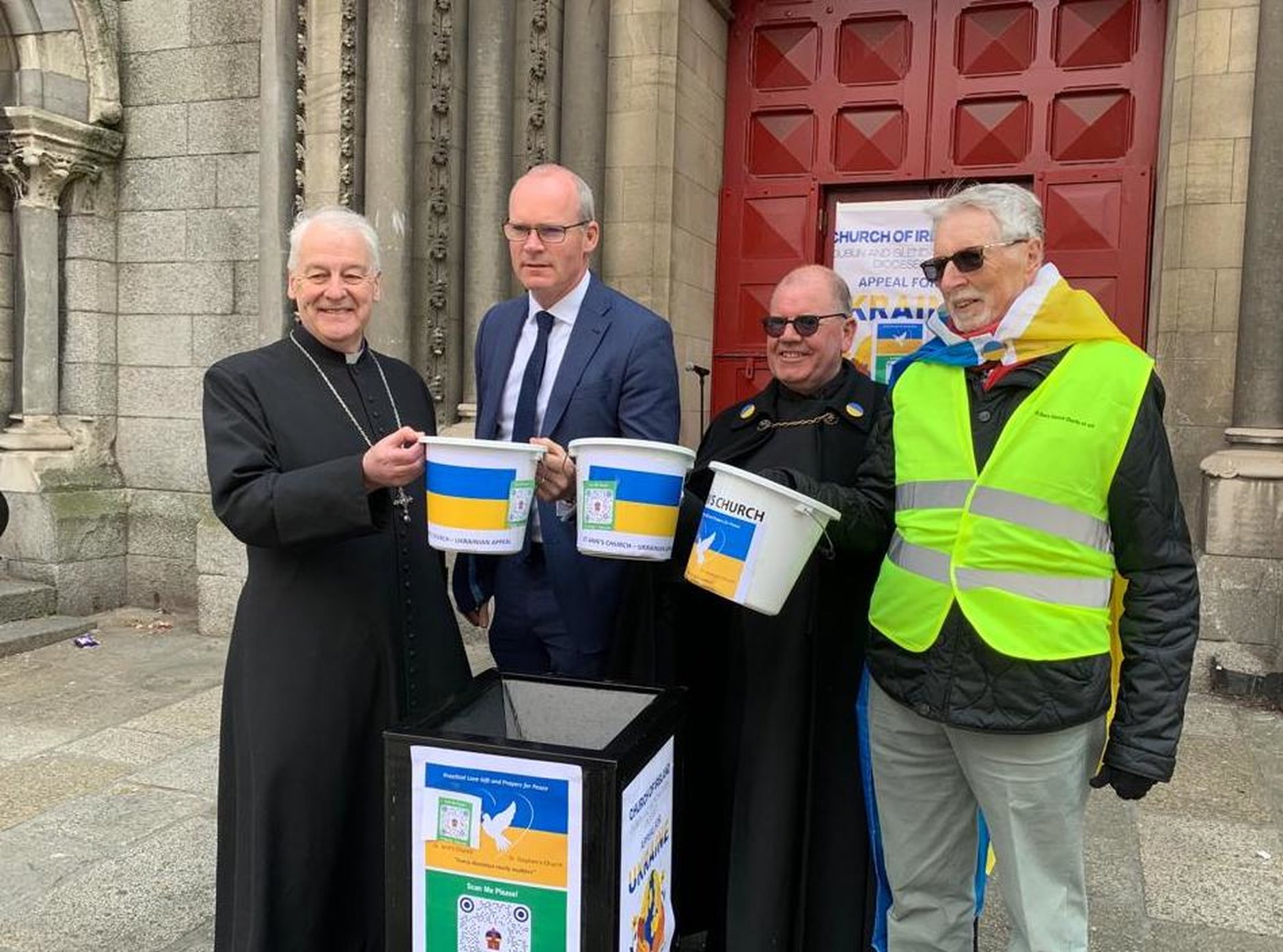 Archbishop Michael Jackson, Minister Simon Coveney, Fred Deane and Desmond Campbell at the launch of the Black Santa sit out for the Ukraine appeal at St Ann's.
