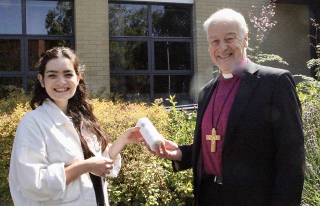 The Revd Rebecca Hamilton of the Pioneer Ministry Team presents Dublin and Glendalough's Pioneer Ministry Candle to Archbishop Michael Jackson.