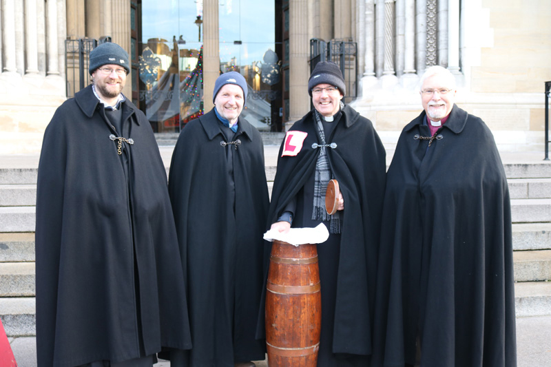 Dean's Vicar Canon Mark Niblock, Bishop Alan Abernethy (Connor), Dean-Elect Archdeacon Stephen Forde, and Bishop Harold Miller (Down and Dromore) launch the Black Santa Sit-out on the steps of Belfast Cathedral on Monday December 18.