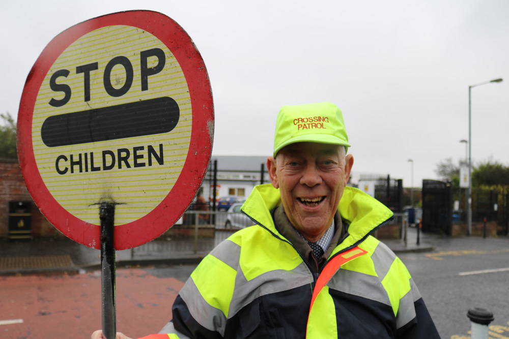 Top lollipop man Ivan Gibson outside Carnmoney Primary School where he has seen children safely across the road for 16 years.