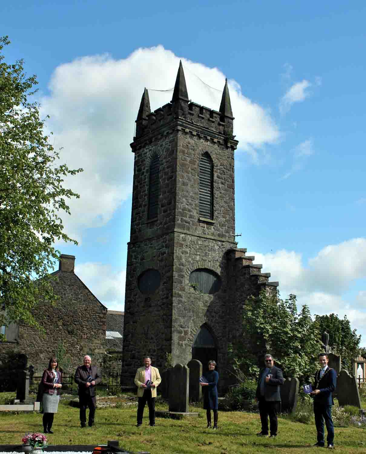 Pictured in front of Old Tower, site of the original church, are, from left: The Rev Emma Carson, curate; Roy Smith, a direct descendant of the Adair family; Cllr Peter Johnston, Mayor of Mid and East Antrim Borough Council; James Perry MBE; Deputy Lieutenant for County Antrim; and the Rev Canon Mark McConnell. Photo: Loraine Watt.