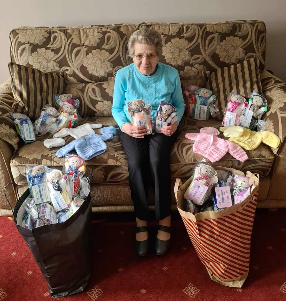 Margaret Marshall surrounded by the 160 teddies she knit for Baby Basics Belfast.