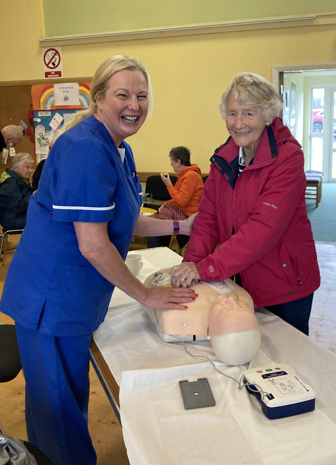 Denise Stone offers advice on use of a defibrillator at the Agherton Parish health and wellbeing event.
