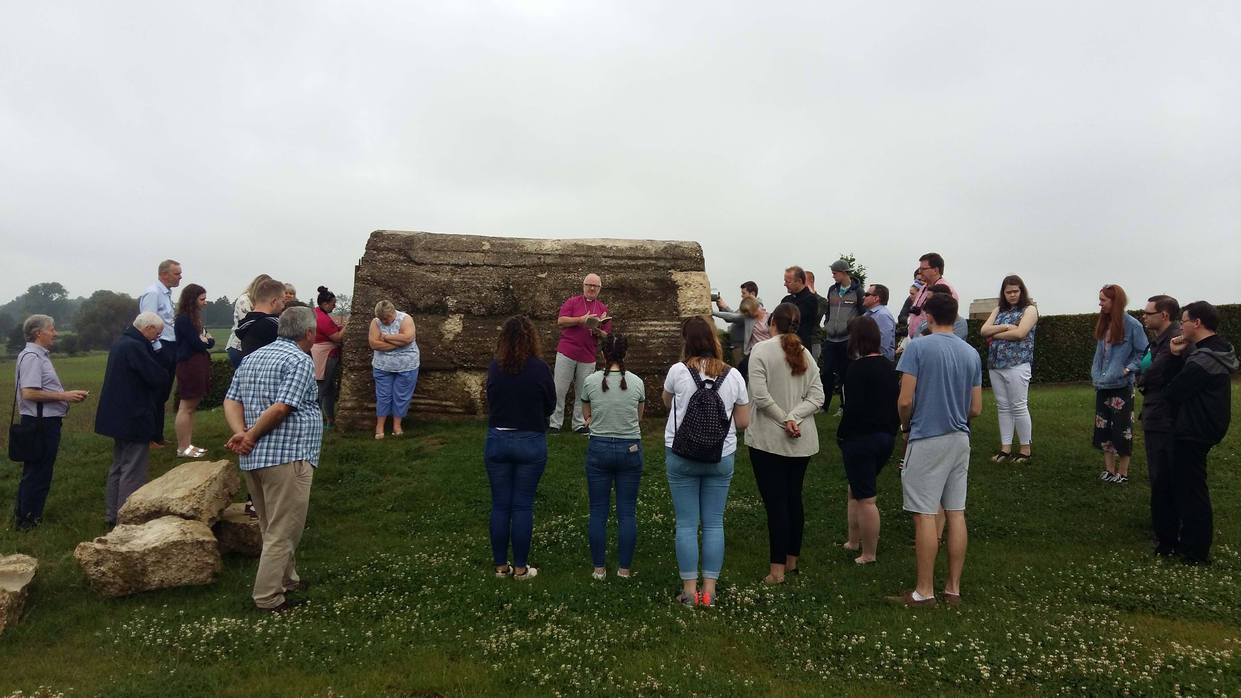 Archbishop Richard Clarke reads a poem at a bunker on the Christmas truce site, at Messines.