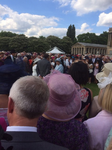 The Queen greets visitors at the party in the palace gardens.