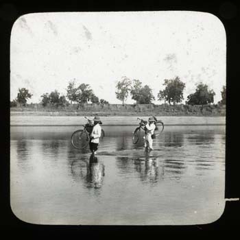 Wading across river (probably River Koel) near Manoharpur, carrying bicycles. This slide shows possibly Bishop Kennedy on the left and the Revd Gerald Dickson on the right