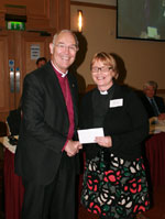 Rev Pat Storey accepts her award from the Archbishop
