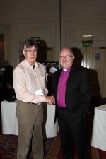 Mr Pauric McGroder accepts a prize from the Archbishop